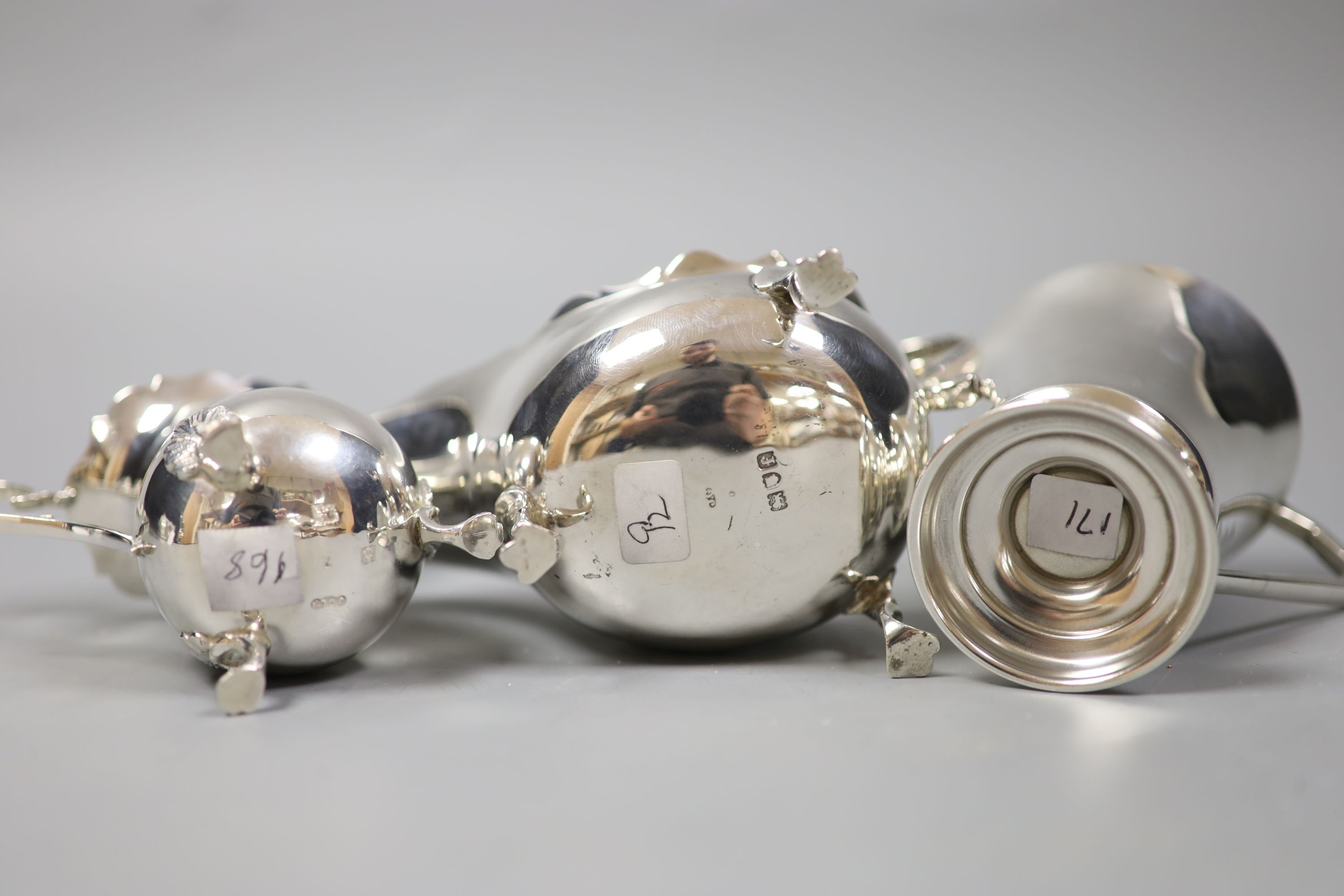 An Edwardian silver sauce boat, London, 1901 and a later silver cream jug and mug, 9oz.